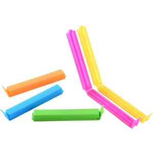 Colourful plastic food sealing clips in pink, yellow, green, orange, and blue arranged in a scattered layout.