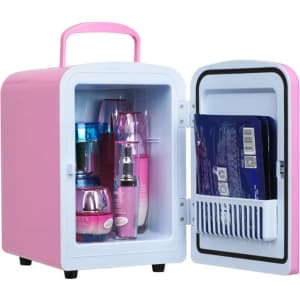 A mini refrigerator in pink and white, featuring various skincare products inside. It has a handle and a small storage compartment.