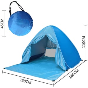 A blue pop-up beach tent with a rounded shape, featuring an entrance, interior space, and a carrying bag.