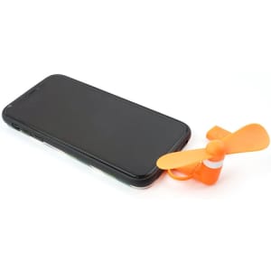 An orange mini fan sits beside a black smartphone, designed for USB connection. It has a small, propeller-like shape.