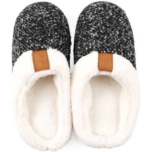 Indoor fleece slippers in black and grey with a soft white lining and a brown accent on the heel. Features a logo.
