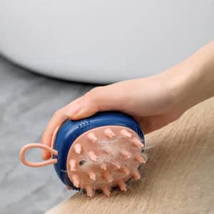 A bath massager brush for pets features a blue and pink design, with soft bristles for grooming.