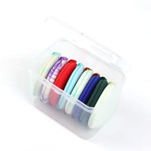 A clear container holding eight non-latex air cushion powder puffs in various colours, including red, blue, green, and purple.