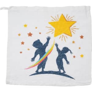 A white compressed towel featuring playful silhouettes of two children reaching for a star, with a rainbow design.