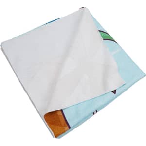 A folded microfiber beach towel, featuring a colourful design on one side and a white underside.