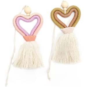 Two heart-shaped car pendants in pink, purple, and olive green with cream tassels and wooden beads.