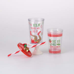 A drink tumbler set featuring two plastic cups, one red and the other clear with festive designs, and a straw lid.
