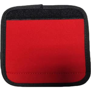 A red neoprene luggage grip with a black trim, featuring a textured surface and a velcro area.