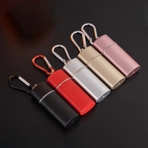 A collection of five outdoor pocket sliding ashtrays with keychain, in red, black, gold, silver, and pink.