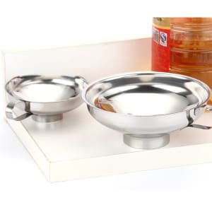 A stainless steel wide mouth funnel with handle, featuring a shiny silver finish, displayed alongside jars.