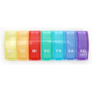 A weekly pill organizer with seven compartments in yellow, red, and blue, each labelled for different days.