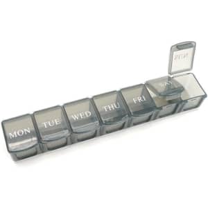 A grey, seven-day pill dispenser with compartments labelled for each day of the week, featuring a clear lid for easy access.