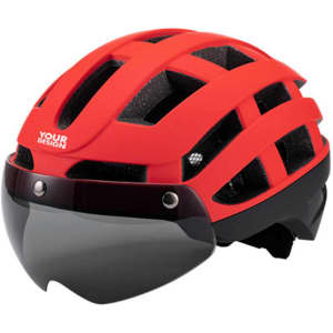 A red cycling helmet with a built-in visor and a branded logo. Features ventilation holes and a sleek design.