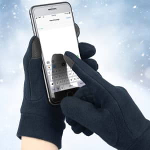 Polar fleece gloves in navy blue with touch screen fingertips, shown interacting with a smartphone.