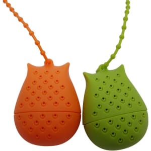 A pair of reusable silicone tea infusers, one orange and one green, shaped like owls, with attached chains.