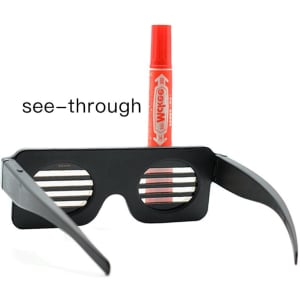 A pair of black dynamic LED glasses with see-through slats, positioned next to a red marker.