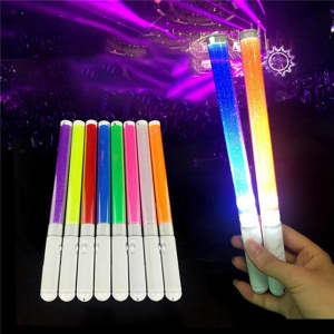Handheld LED glow sticks in various colours, featuring white handles and glowing brightly against a concert backdrop.