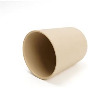 A bamboo fibre coffee cup in a light beige colour with a smooth surface and no lid. It has a subtle branding detail.