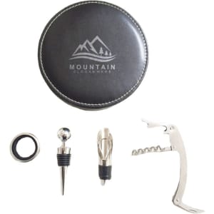 A round black leather case containing a corkscrew, pourer, stopper, and foil cutter set for wine.