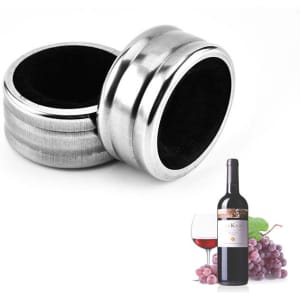 Two stainless steel wine drip rings with a black inner lining, set against a background featuring a wine bottle and glass.