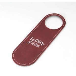A maroon door hanger sign with a top hole for hanging and a blank area for custom design. It has a stitched border.