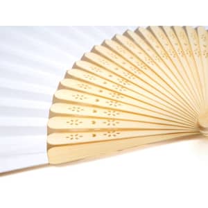 A traditional paper folding fan with bamboo ribs, featuring a white design and decorative cutouts on the ribs.