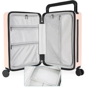 A wheeled luggage bag in soft pink with a black handle, featuring multiple interior compartments and a zippered section.