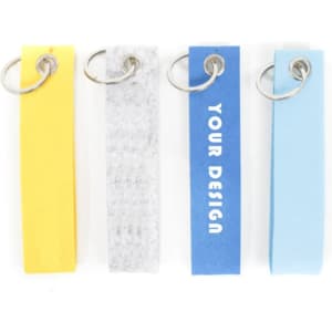 A set of four custom felt key chains in yellow, grey, blue, and light blue, each with a metal ring.