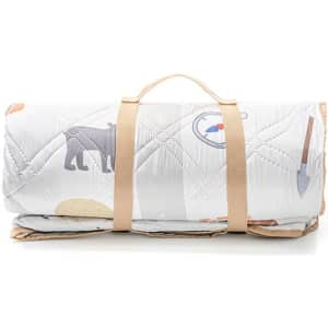 A rolled-up picnic blanket with a carrying strap, featuring a patterned design in neutral tones.
