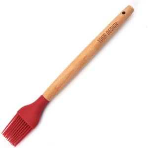 A silicone basting brush with a red head and a wooden handle, featuring a branding logo.