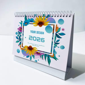 A desk flip calendar featuring a floral design with vibrant colours, displaying the year 2026. It has a metal spiral binding.