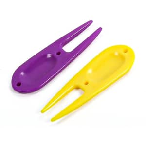 A golf divot fork in purple and yellow, featuring two pointed prongs and a rounded body with a hole.