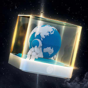 A 3D paper sculpture calendar features a blue globe and an astronaut inside a transparent cube, illuminated with light.