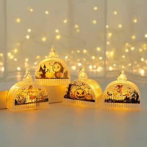 Four decorative pumpkin light lamps in orange and clear designs, featuring Halloween motifs against a softly lit background.