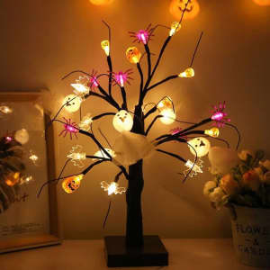 A lighted Halloween birch tree with black branches, featuring colourful ghost and spider decorations, illuminated with soft lights.