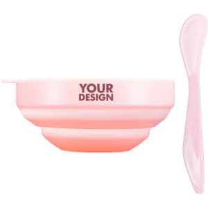 A pink facial mask mixing bowl set featuring a bowl and a matching spatula. The bowl has a logo area.