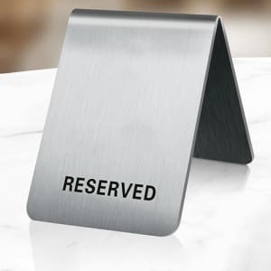 A stainless steel table tent sign with a sleek, brushed finish, featuring a logo on one side.