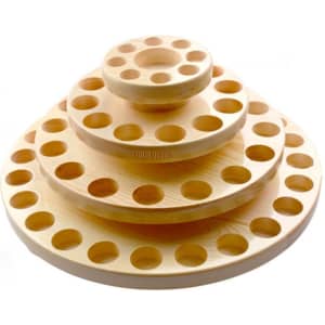 A wooden essential oil storage carousel with three tiers, featuring circular holes for bottles, in a natural timber finish.