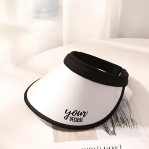 A white sun visor hat with a black band and a logo, featuring a customizable design area.