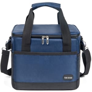 A navy blue insulated cooler bag with dual handles, a detachable strap, and a small branding logo on the front.