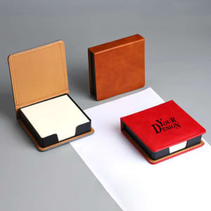 A PU leather note storage box in orange and red, containing blank notepad paper, with one box open, revealing the contents.