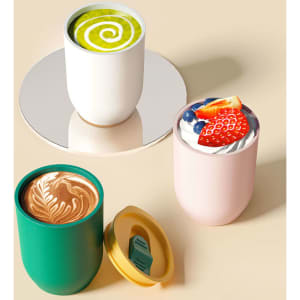 A set of three plastic egg-shaped tumblers in white, pink, and green, each with a lid, showcasing various drinks.