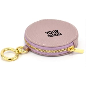 A round coin purse in soft lavender with a gold zipper and keyring attachment. It features a placeholder for custom design.