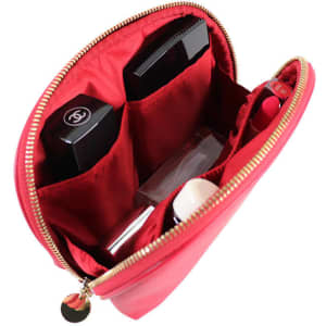 A mini shell-shaped cosmetic bag in bright pink, featuring multiple compartments for toiletries and a logo inside.