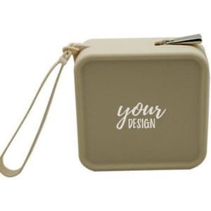 A square silicone makeup bag in a beige colour with a zip closure and a wrist strap. It has a logo on the front.