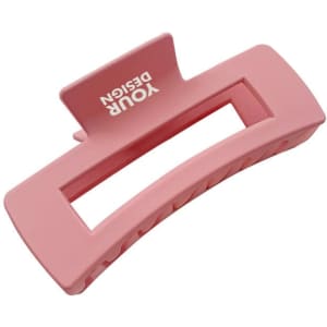 A pink plastic square hair claw clip with a branding logo. It features a rectangular design with a textured grip.