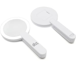 A round, white lighted makeup mirror with a handle, featuring a compact design and a logo.