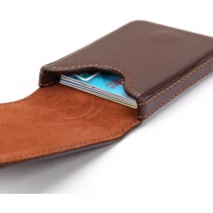 A brown PU leather business card holder displaying cards inside, featuring a suede-like interior.