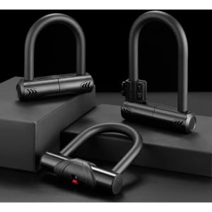 A set of three black U-shaped bike locks displayed on black boxes, featuring various designs and a logo.