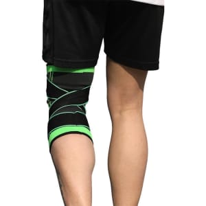 A knitted strap sports knee pad in black with green accents, positioned on a wearer's knee.